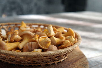 mushrooms chanterelles a small ginger in a basket a wicker bowl on the table