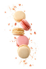 Sweet raspberry and vanilla macaroons macarons with crumbs falling flying isolated on  white background.