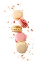 Rolgordijnen Sweet raspberry and vanilla macaroons macarons with crumbs falling flying isolated on  white background. © BarTa