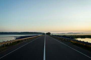 Calm empty asphalt road without cars at sunrise