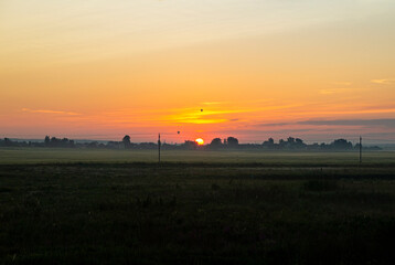 Fototapeta premium Calm beautiful sunrise over a rural field