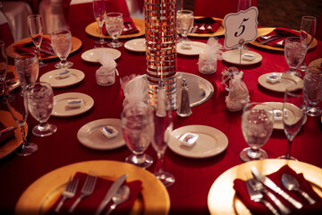 gorgeous red and gold wedding table set up for guests