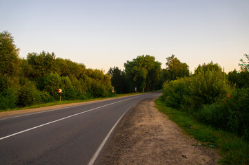 Fototapeta na wymiar Empty road turn at dawn