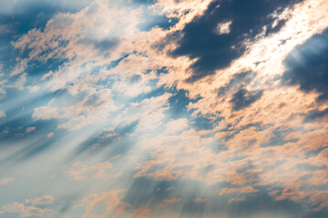 Beautiful cloudscape with pink rays of the sun penetrating