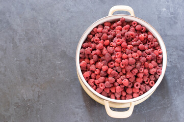 a full pan of ripe raspberries and a spoon for jam, a large harvest of healthy berries, a healthy diet. Favorite delicacy, preservation of Natural vitamins for the winter