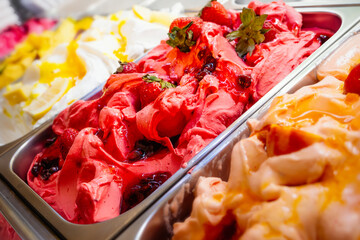 Various Gelato in a store window. Multicolor Ice cream rack in a snack bar close-up.