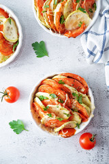 Zucchini tomato casserole with pepper and parsley in white bowl