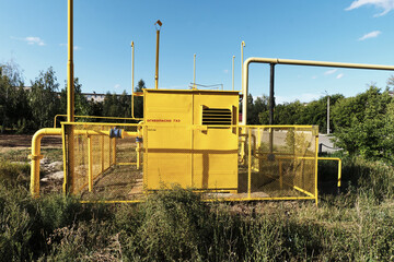 yellow gas station with warning signs front view