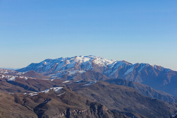 chain of mountains covered by snow and clouds in Santiago Chile