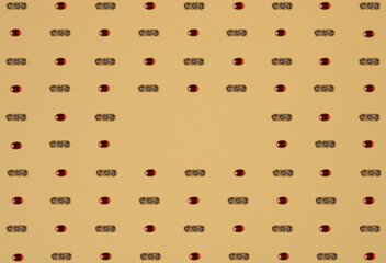 Red and brown pills pattern on yellow background. Minimal lay out arrangement.