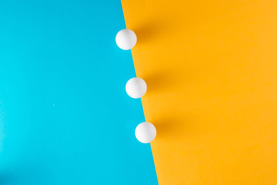 Abstact concept with white balls on blue and yellow background. Minimal lay out arrangement.