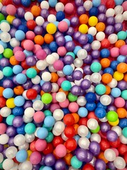 Fototapeta na wymiar Plastic multicolored balls on the playground for preschool children. Bright fun and happy background 