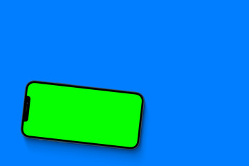 Smartphone with a green screen. Chroma key. Isolated on a blue background.