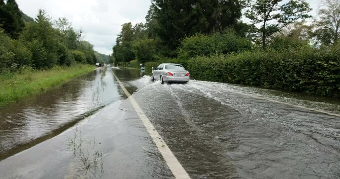 Car driving in water, Biel lake inundation of july 2021