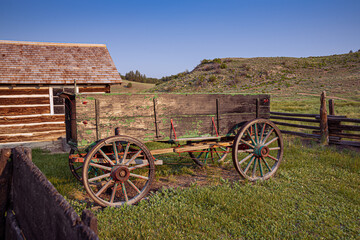 Fototapeta na wymiar old farm wagon texture log cabin fence hill pine tree morning clear sky 