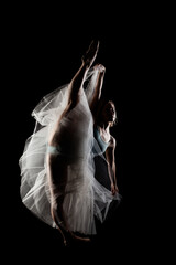 ballerina with a white dress and black top posing on black background © Nikola Spasenoski