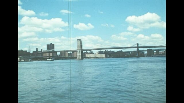 Archival footage of Brooklyn Bridge in New York city. Cityscape from a boat tour on East river of Manhattan Upper Bay of New York City in 1976. Archival of Manhattan skyline. Close up view.