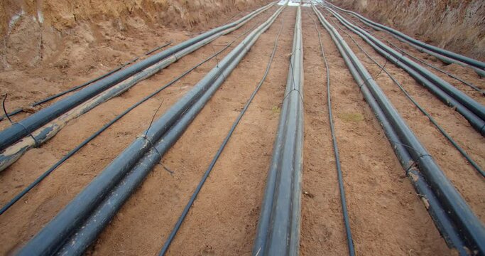 Many cables with zip ties to hold them together in the trench, laying cables, 4k