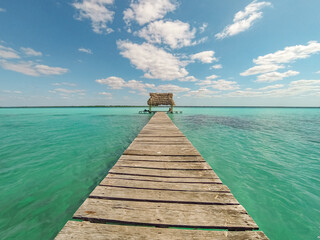 Fototapeta na wymiar Laguna de Bacalar, pier in Mayan Mexico in Quintana. Beautiful turquoise water lagoon in the Mexican Caribbean