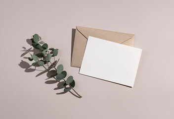 Summer wedding stationery mockup. Plain greeting cards, invitations, and eucalyptus leaves on a...