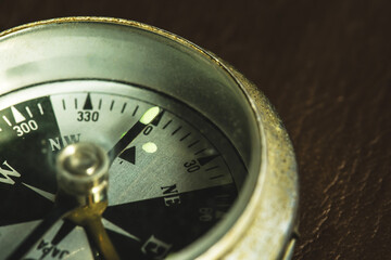 The compass pointing the north. Has copy space,macro photo,vintage object