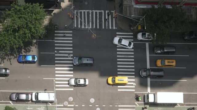 A top down aerial view of a busy Manhattan street during the day.  	
