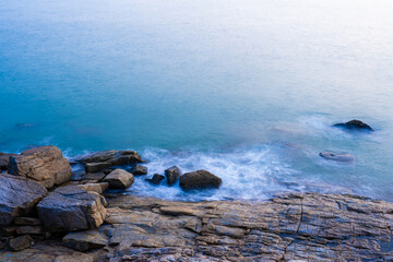 Nature view for soft wave and stone in the sea in morning for background and texture