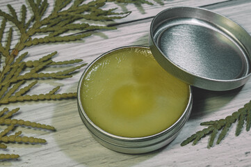 Natural handmade cosmetics in aluminum containers. Focus on the contents of the container and the lid