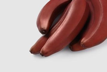 Tasty red baby bananas on white background, above view