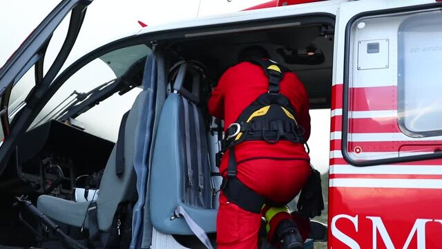 FAGARAS MOUNTAINS, ROMANIA - Jul 16, 2020: A team of mountain rescuers and medical crew by the helicopter in the Fagaras mountains to rescue a tourist who suffered a knee injury in HD