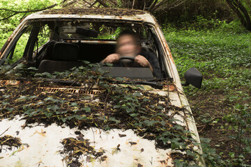 Concept wrong-way driver selfie with motion blur in a junk car closeup