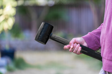 woman holding a rubber hammer