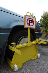 Front car wheel clamped for illegal parking at the road side, a violation car park.  