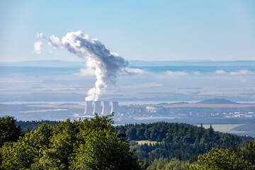 Lignite power plant with column of smoke under blue sky