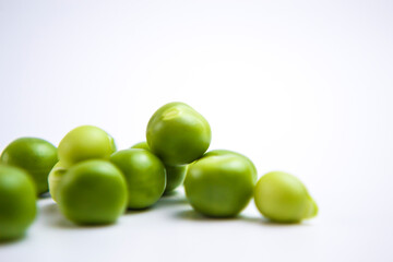 Falling green peas isolated on white background with clipping path