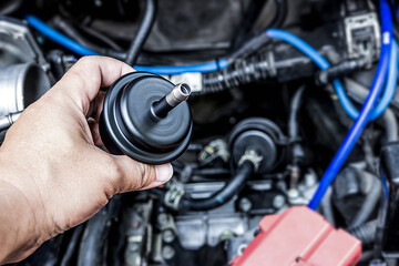 Hand a man hole old oil gear filter of car for change and maintenance in engine room service concept