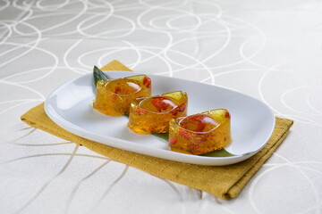 chinese dessert cold jelly with herb gui Hua flower yellow pudding in yuan bao money shape asian banquet halal menu