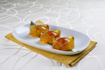 chinese dessert cold jelly with herb gui Hua flower yellow pudding in yuan bao money shape asian banquet halal menu