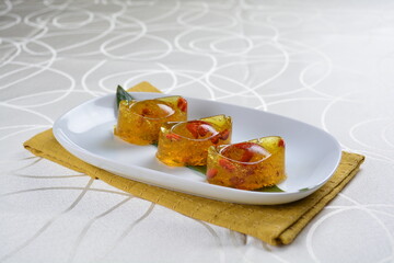 chinese dessert cold jelly with herb gui Hua flower yellow pudding in yuan bao money shape asian banquet halal menu