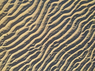 Fototapeta na wymiar Sand texture. Sandy beach for background. Top view