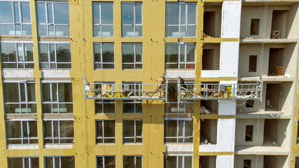 Building external wall thermal insulation with mineral wool. Exterior passive house wall heat insulation with mineral wool. Insulation the facade of commercial building. Energy efficiency