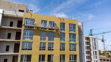 Building external wall thermal insulation with mineral wool. Exterior passive house wall heat...