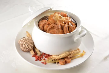  Chinese traditional luxury cuisine buddha jump over the wall with seafood abalone, sea cucumber, shark's fin, scallop and meat in hot herbal soup clay pot in white gold background asian menu for new y © perfectloop