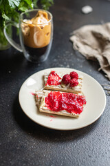 sandwich sweet jam and cup of coffee berry jam, butter, organic whole grain diet bread crisp on the table, healthy meal snack copy space food background rustic 