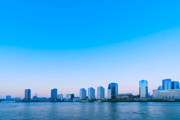Naklejka premium Morning, residential buildings by the sea of Rotterdam, Netherlands, blue sky and sea, quiet and peaceful shot