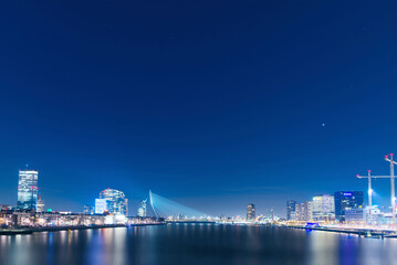 Night view of Rotterdam in the Netherlands, brightly lit, a bustling scene
