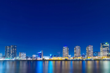 Fototapeta na wymiar The river in Rotterdam in the Netherlands at night; a modern city, brightly lit