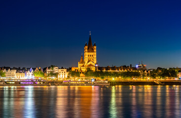 Naklejka na ściany i meble Majestic cathedral in Cologne, Germany, beautiful park by the river, night view of city. Long shot