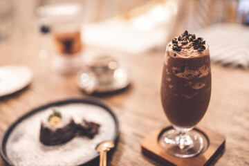 Chocalate smoothy wite chocolate chip and some snack on the table in cafe