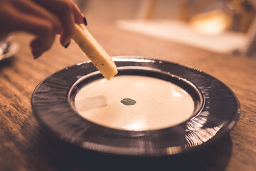 Obraz premium Mushroom soup with bread to dip in cafe - close up